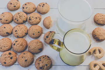 Close up cookies and glass of milk on wooden table - Vintage Sty
