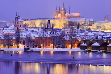 Papier Peint photo Prague Night snowy Prague gothic Castle and St. Nicholas' Cathedral with Charles Bridge, Czech republic