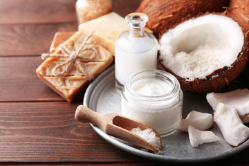 Spa coconut products on dark wooden background
