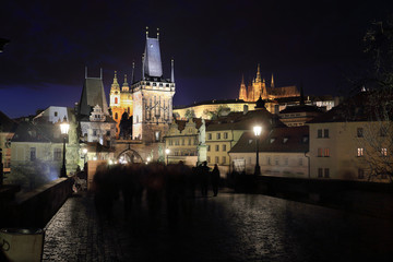 Colorful Prague gothic Castle with St. Nicholas' Cathedral from Charles Bridge above the River...