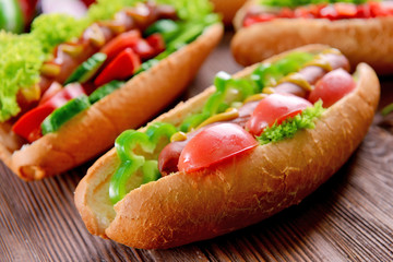 Hot dogs on wooden background closeup