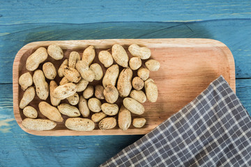 Peanuts in shells on wood background