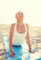 Fototapeta na wymiar young woman making yoga exercises outdoors