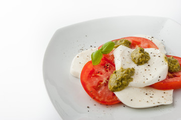 Caprese salad on the white square plate horizontal