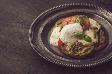 Caprese salad in the vintage metal plate horizontal