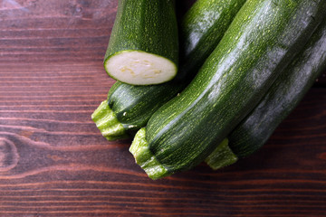 Fresh zucchini on wooden background