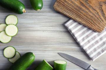 Fresh sliced zucchini on cutting board, on wooden background