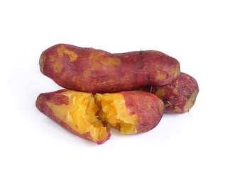 Whole purple yams photographed on a white background.