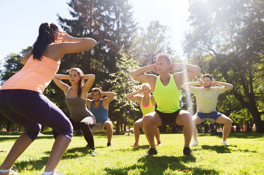 Group Of Friends Or Sportsmen Exercising Outdoors