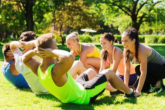group of friends or sportsmen exercising outdoors