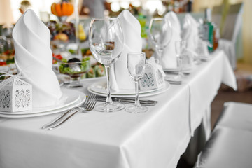 Banquet wedding table with dishware.