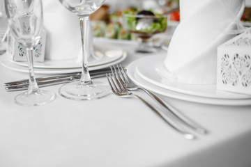 Banquet wedding table with dishware.