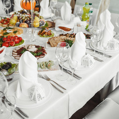 Banquet wedding table with dishware.