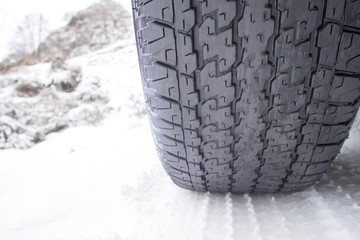 Close up shot of a wasted car tire in snow at winter