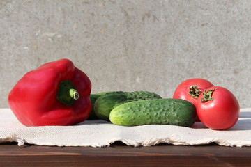 Ingredients for the vegetable salad: a pepper, three cucumbers and two tomatoes.
