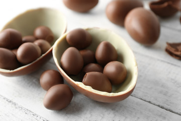 Chocolate Easter eggs on white wooden background