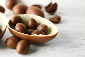 Chocolate Easter eggs on white wooden background