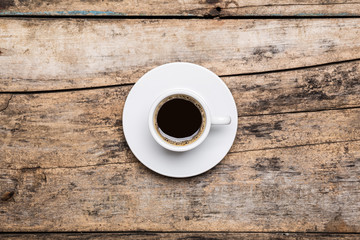 Cup of strong black coffe on wooden table
