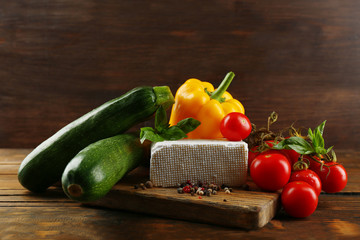 Fresh ingredients for preparing zucchini rolls on wooden background