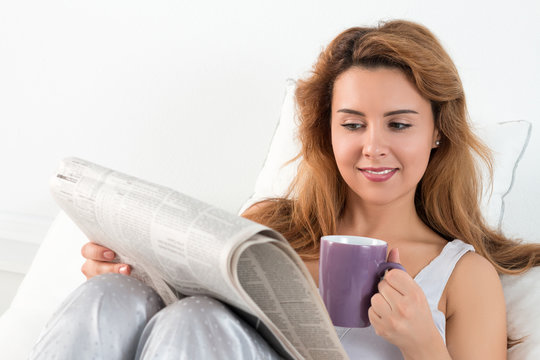 Woman reading morning newspapres