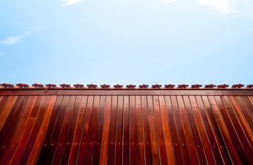 red wood table on blue sky background