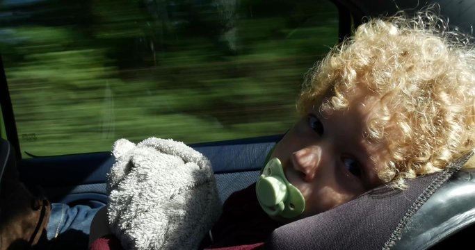 close up of a little boy with a pacifier in the mouth