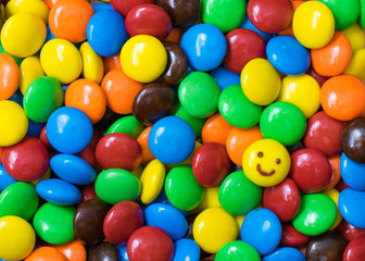Fototapeta na wymiar Smile face on colorful chocolate balls