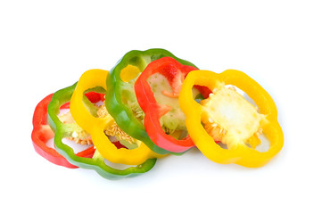 red, green and yellow sliced pepper isolated on white background