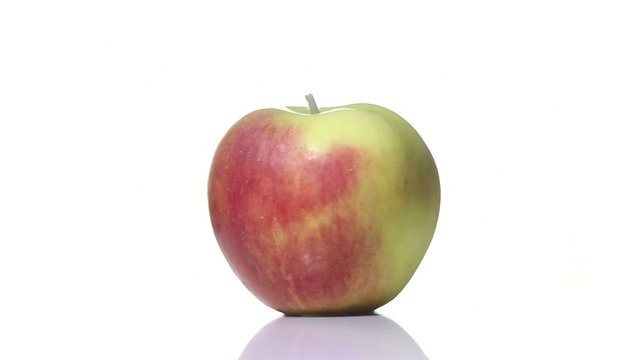 Apple spinning around on a white background
