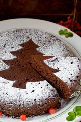 Homemade chocolate Christmas cake sprinkled with sugar powder
