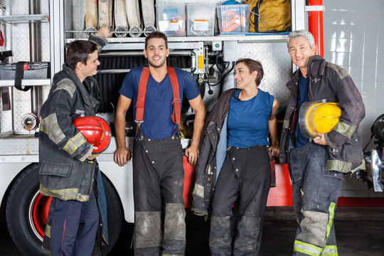 Team Of Confident Firefighters At Fire Station