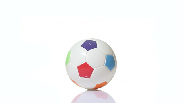 Colorful soccer ball spinning around on a white background.