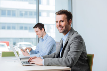 Two business people working in office