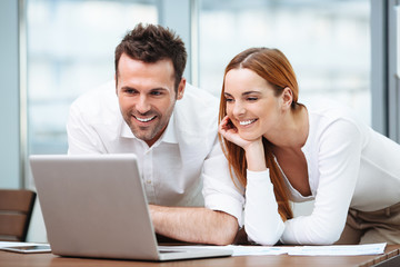 Two business partners working on laptop
