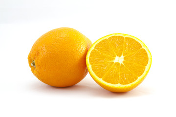 Pair of oranges on white background, one of them sliced in half