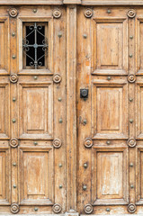 Ancient wooden door with iron grille