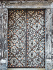 richly decorated old iron door reinforced with steel belts and rivets