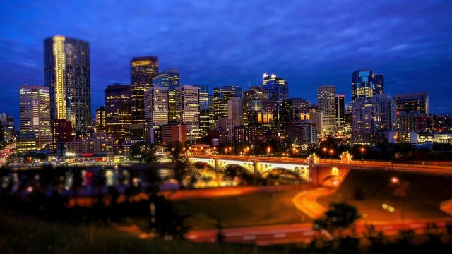Night shot of downtown Calgary, time lapse, business names are blurred out, Ultra HD, 4K