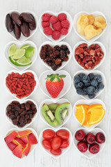 Mixed Fruit Selection. Fresh mixed fruit background selection with fruits high in antioxidants, vitamin c and dietary fibre in heart shaped dishes.