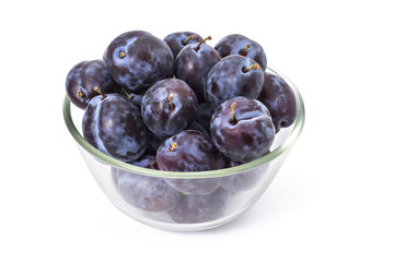 Fresh ripe plums in a bowl on white background