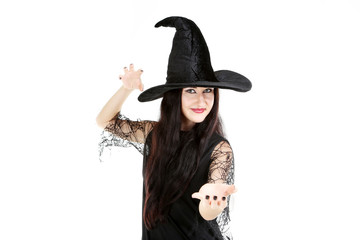 Young brunette witch on a white background