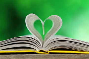 Open book on grey wooden background