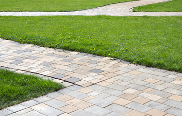 paved path / paved path and green meadow