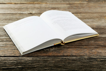 Open book on grey wooden background