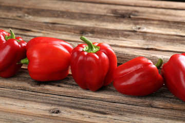 Red peppers on a brown wooden background