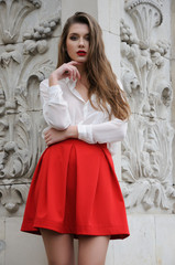 Fototapeta premium Beautiful young girl in red