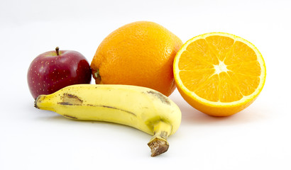 Banana, apple and a pair of oranges, one of them sliced in half. White background.