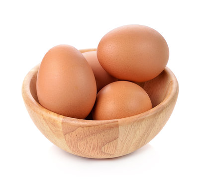 egg  in a wooden bowl isolated on white background