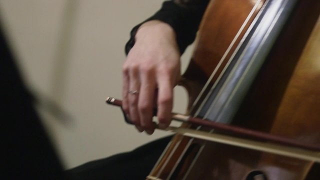 woman plays a violoncello