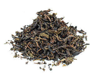 dry black tea leaves isolated on white